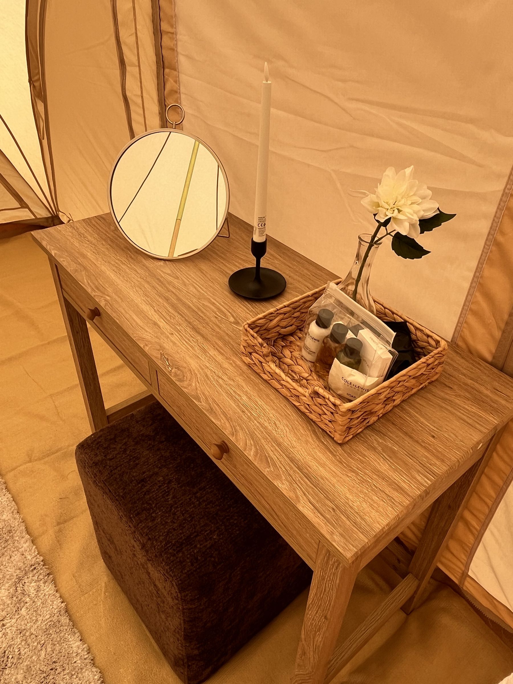 A console table dressed with candles and glassware