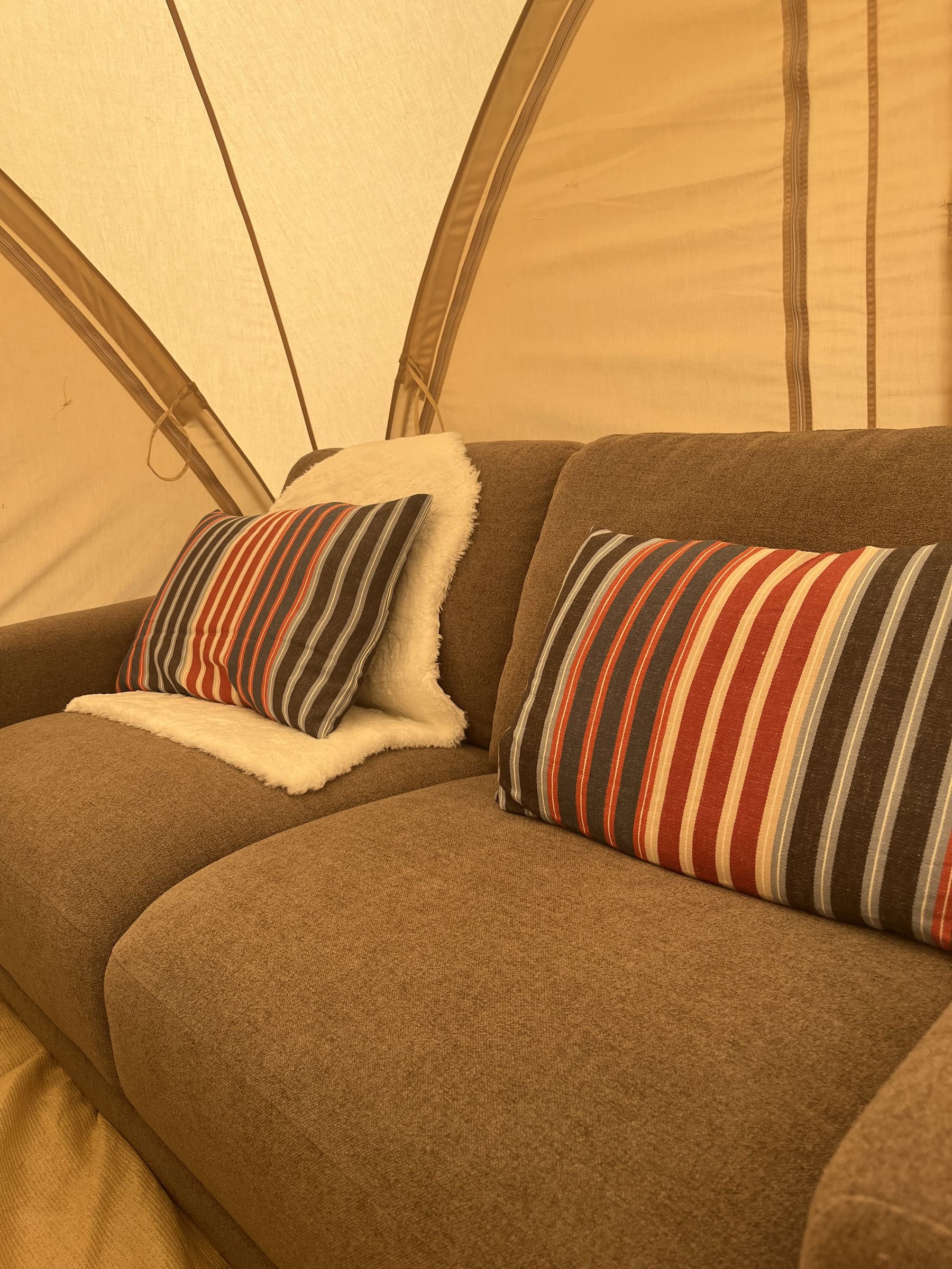 A sofa and low table inside a tent