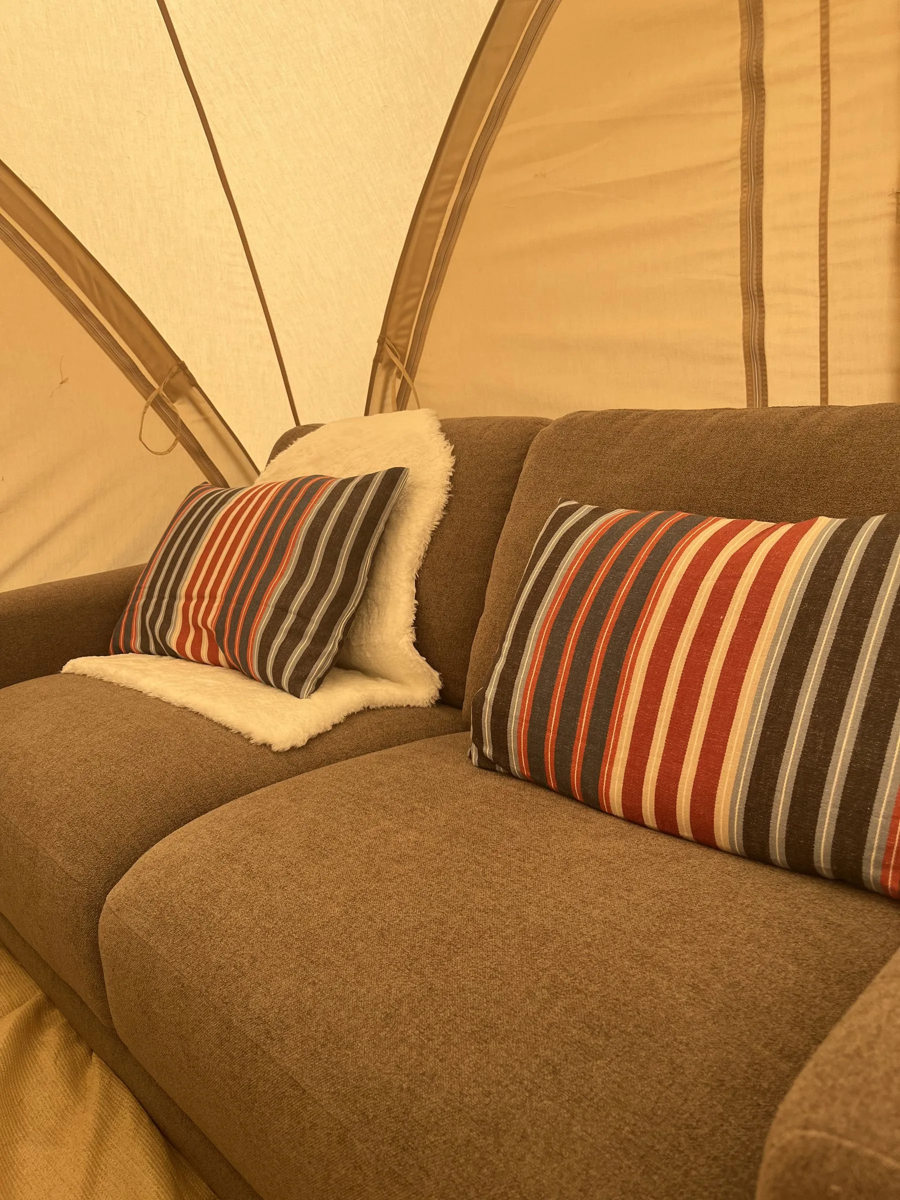A sofa and low table inside a tent