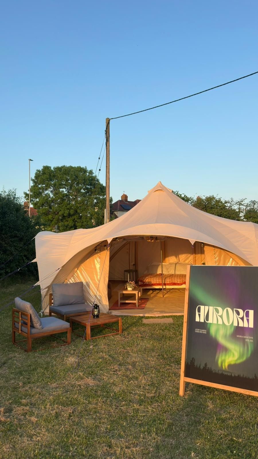 Looking into a lit tent at sunset from outside